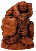 A BAMBOO CARVING OF A BOY WITH A THREE LEGGED TOAD