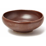 A MAROON PORCELAIN BOWL WITH ROUNDED EDGES