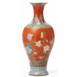 A 'FAMILLE ROSE' CORAL-RED GROUND BALUSTER VASE