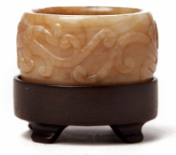 A CARVED RUSSET JADE ARCHER'S RING