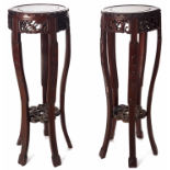 A PAIR OF CIRCULAR BLACKWOOD STANDS