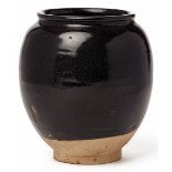 A BLACK GLAZED POTTERY VASE