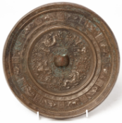 A LARGE SILVERY BRONZE INSCRIBED ZODIAC MIRROR