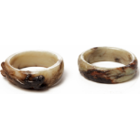 TWO CARVED WHITE AND RUSSET JADE BANGLES