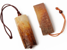 AN ARCHAISTIC CARVED JADE SWORD SLIDE AND A PENDANT