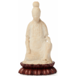 A CARVED STONE FIGURE OF GUANYIN