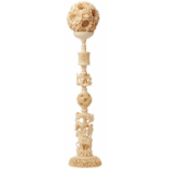 A LARGE CHINESE CARVED IVORY 'PUZZLE BALL' ON STAND