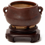 A SMALL BROWN GLAZED TWIN HANDLED CENSER