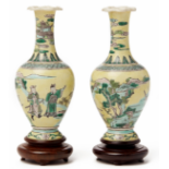 A PAIR OF SMALL YELLOW GROUND 'FAMILLE VERTE' BALUSTER VASES