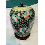Vintage oriental lidded vase on wooden stand. Stands 28cms tall, vase only