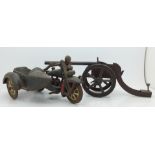 A cast metal toy cannon and a cast iron motorcycle and sidecar