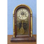 A 19th Century American 8-day alarm mahogany shelf clock, made by Waterbury Clock Co., c.