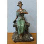 A French Art Deco bronze figure of a seated girl playing tambourine,