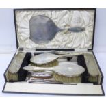 A silver six piece vanity set with a silver handled nail buff, shoe horn and button hook,