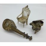 A filigree white metal miniature chair,