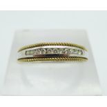 A 9ct gold, two colour ring set with diamonds, 2.