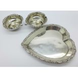 A pair of silver salts and a silver heart shaped tray,