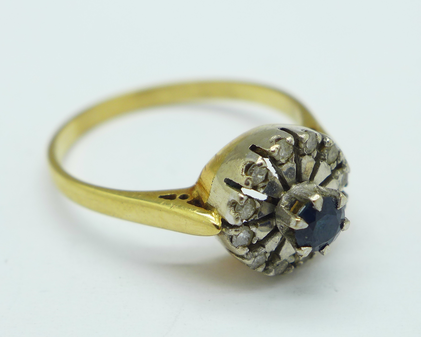 A yellow metal, diamond and sapphire cluster ring, 3.