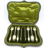 A cased set of six silver spoons with sugar bows with decorative backs, in a shaped fitted case,