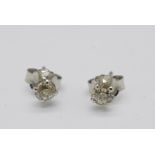 A pair of 18ct white gold diamond stud earrings, total diamond weight 0.