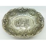 A white metal embossed dish with tavern scene,