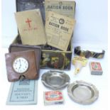 A tin of assorted items including plated ware, travel clock, pocket watch, ration books, etc.