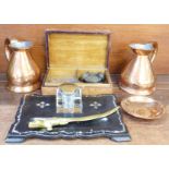 A papier mache and mother of pearl inlaid inkstand, a brass letter opener, two copper jug measures,