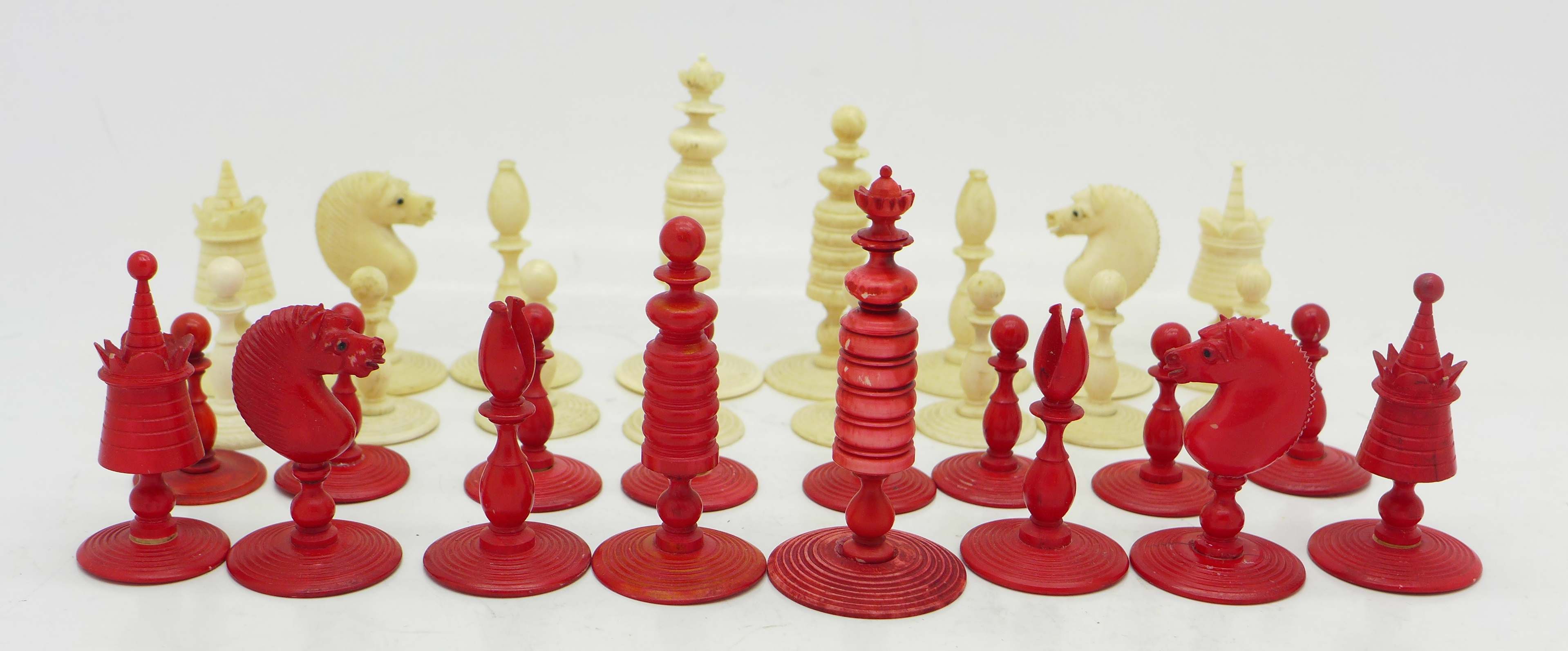 A chess set, (three replacement bases, two red,