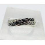 A 9ct gold, black and white diamond crossover ring, 1.
