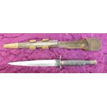 A military issue commando dagger and scabbard (Fairburn Sykes pattern)