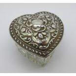 A silver topped heart shaped glass pot