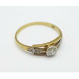 An Art Deco 14ct gold and diamond solitaire ring with old cut diamond set shoulders, 1.