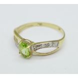 A 9ct gold, peridot and diamond chip ring, 0.