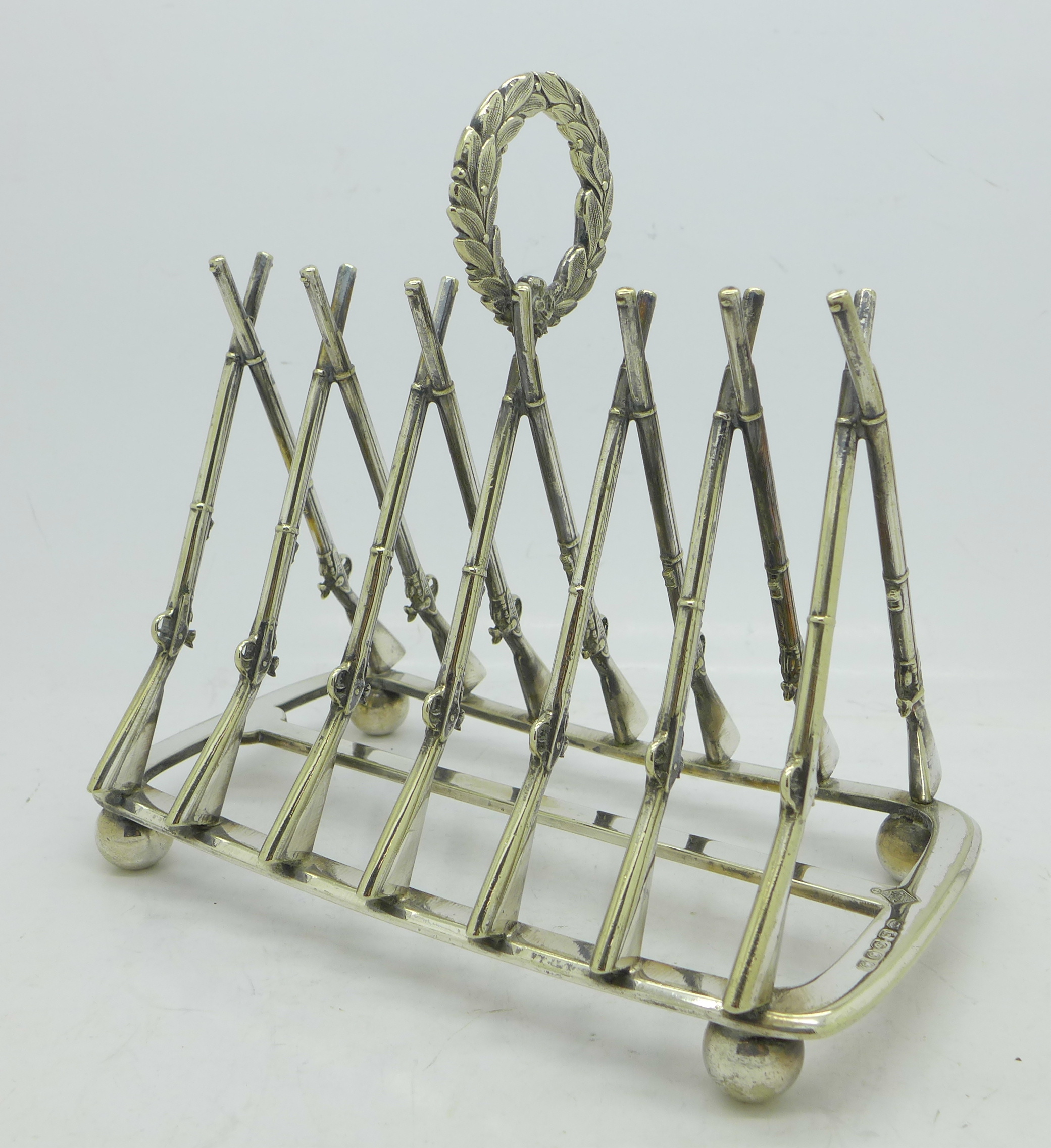 A 19th Century silver plated toast rack with crossed muskets