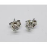 A pair of 18ct white gold diamond stud earrings, total diamond weight 0.