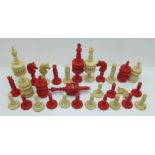A part chess set in white and stained red bone