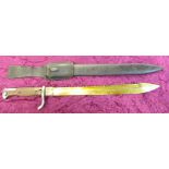 A saw back bayonet and scabbard,