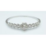 An 18ct white gold and diamond bangle set with thirty-seven diamonds, 13.