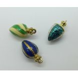 Three yellow metal and enamel egg charms