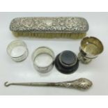 Two silver napkin rings, silver backed brush,