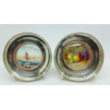 A pair of silver dishes mounted with hand painted Worcester plaques