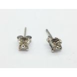 A pair of white metal and diamond earrings