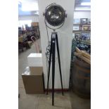 A chrome theatre style spotlight on a tripod base