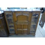 A carved oak side by side bureau bookcase