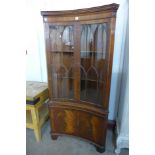 A Bevan & Funnell mahogany concave freestanding corner cabinet