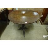 A George III oak circular tilt top tripod table