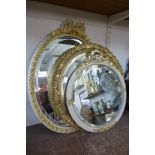 A gilt framed mirror and two parcel gilt framed mirrors