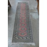 A salmon ground runner rug,