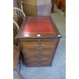 A mahogany filing chest with a tooled leather top