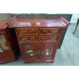 A chinoiserie red lacquered four drawer cabinet